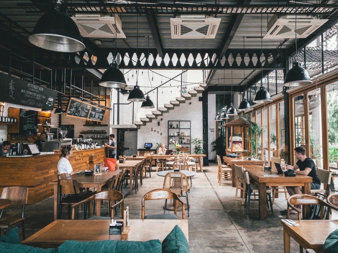 The bistro's dining room, with wooden tables and hanging pendant lights